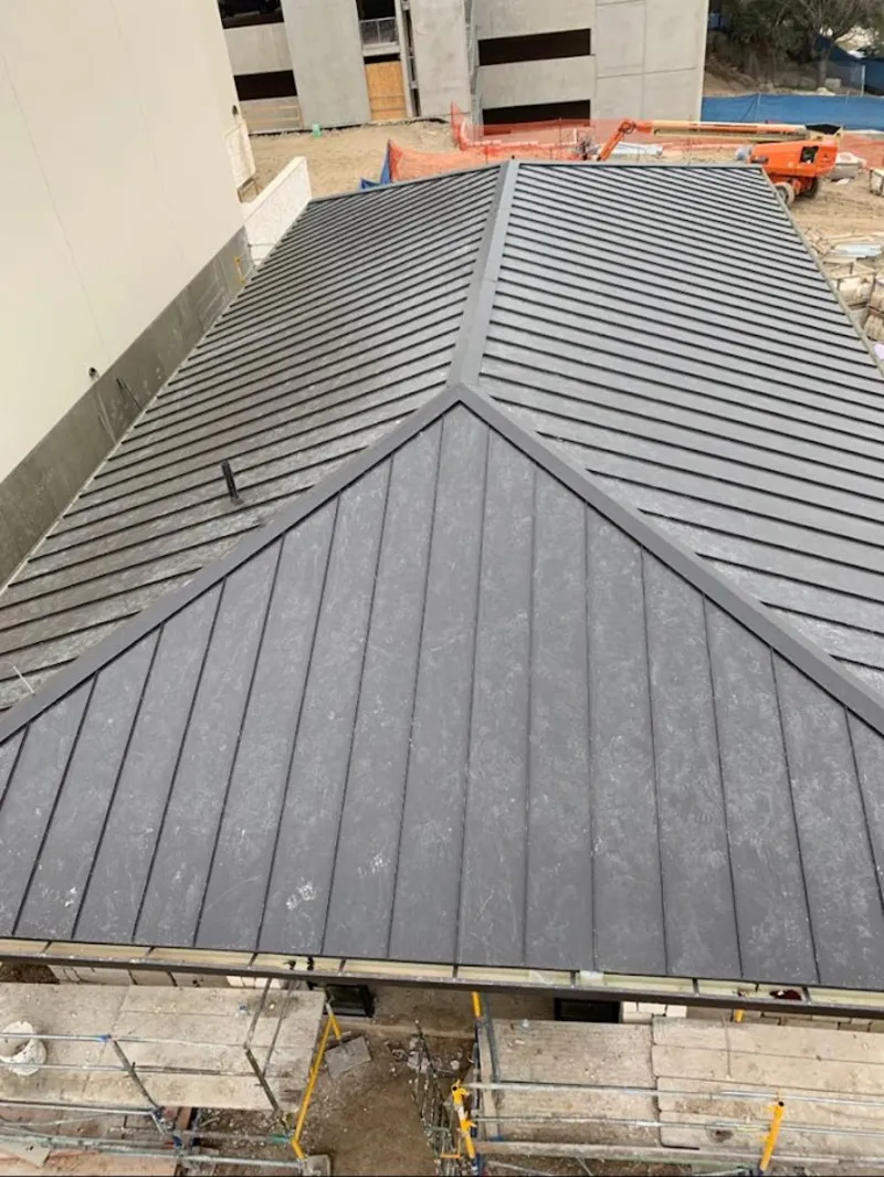 Commercial metal roof construction with crane equipment in James Island