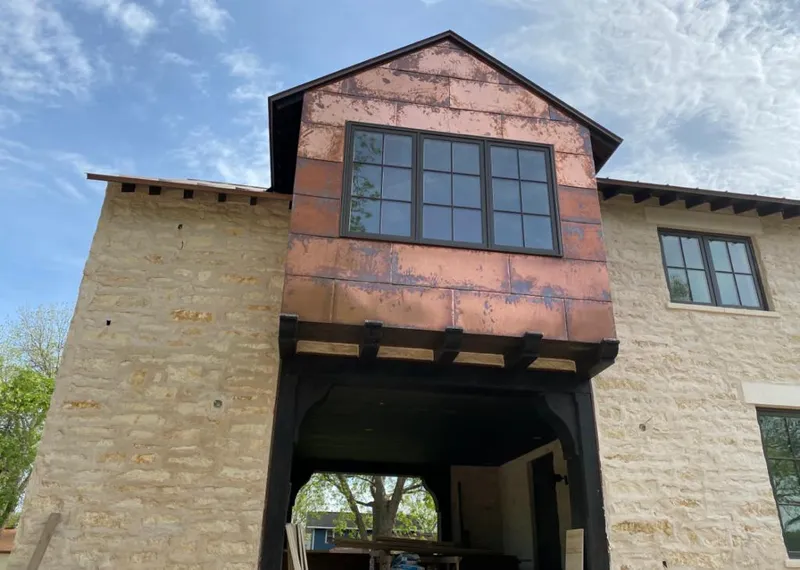 Copper metal panel facade on a stone building for Skylight Installation in James Island